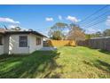 Large fenced backyard with green grass, perfect for outdoor activities and relaxation at 1073 Kenwood Dr, Dunedin, FL 34698