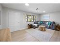 Bright living room featuring a comfortable gray sectional and stylish decor at 1073 Kenwood Dr, Dunedin, FL 34698