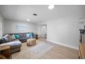 Open-concept living area with modern finishes, including light wood floors and recessed lighting at 1073 Kenwood Dr, Dunedin, FL 34698