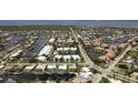 Aerial view of waterfront community with canals, homes, and lush landscape, showcasing location at 260 Coronado Dr, Punta Gorda, FL 33950