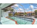 Screened-in pool with brick trim and canal view; perfect for relaxing and enjoying waterfront living at 260 Coronado Dr, Punta Gorda, FL 33950