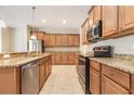 Bright kitchen with granite countertops, stainless steel appliances, and ample cabinet space at 11621 Ashton Field Ave, Riverview, FL 33579