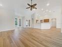 Bright living room features a ceiling fan, and beautiful wood-look flooring at 13210 Essman Ave, Port Charlotte, FL 33953