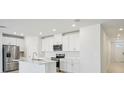 Bright, modern kitchen with stainless steel appliances, white cabinets and a spacious design at 1859 Draughton Dr, Zephyrhills, FL 33541