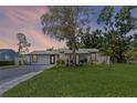 Charming single-story home featuring a spacious front yard, landscaped lawn, and a quaint covered entryway at 2110 W Farwell Dr, Tampa, FL 33603