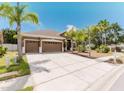 Attractive single-story home featuring a lush front yard, a three-car garage, and a serene, well-maintained landscape at 2707 Wood Pointe Dr, Holiday, FL 34691