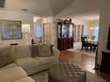 Inviting living room showcasing hardwood floors, modern furnishings, and dining room at 420 S Brockfield Dr, Sun City Center, FL 33573
