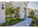 Charming front porch with stone paver walkway, lush greenery, and space to sit and relax at 4754 Manning Ct, Sarasota, FL 34240