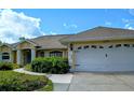 Inviting single-story home featuring attached two-car garage and manicured front yard at 4875 Hansard Ave, North Port, FL 34286