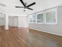 Bright living room featuring hardwood floors, large windows, and a modern ceiling fan at 5225 20Th N St, St Petersburg, FL 33714