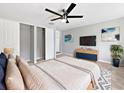Comfortable main bedroom with a ceiling fan, walk-in closets, and a dresser with a television at 5225 20Th N St, St Petersburg, FL 33714