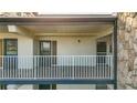 Condo balcony with painted floors, white railing and exterior hall access at 6100 12Th S St # 313, St Petersburg, FL 33705