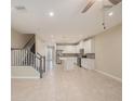 Spacious living room with tile floors, access to the kitchen, and stairs to the second floor at 6703 Citrus Creek Ln, Tampa, FL 33625