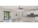Open concept living space with sliding glass doors, natural light, and a view of the kitchen at 7308 Hermes Ct, Apollo Beach, FL 33572