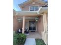 Charming front porch with seating, decorative plants, and a stylish entryway with a stone accent wall at 1212 Georgia Trace Ave, Valrico, FL 33596