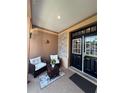 Cozy front porch with comfortable seating, a decorative rug, and an inviting entryway with double doors at 1212 Georgia Trace Ave, Valrico, FL 33596