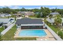 Aerial view of a fenced backyard featuring a pool, screen-enclosed patio, and seating at 14506 Sutter Pl, Tampa, FL 33625