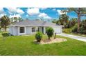 Beautiful single-story home with arched windows, a two-car garage, and well-kept front yard at 2706 Flagami Ln, North Port, FL 34286