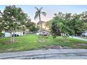 Cozy home with mature trees, a verdant lawn, and basic landscape at 663 68Th S Ave, St Petersburg, FL 33705