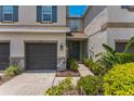 Charming home exterior featuring a garage, welcoming front door, and colorful landscaping at 8126 Muddy Pines Pl, Tampa, FL 33635