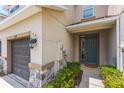 Inviting home exterior featuring a garage, front door, and well-maintained landscaping at 8126 Muddy Pines Pl, Tampa, FL 33635