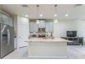 Modern kitchen with stainless steel appliances, granite countertops, and a large center island at 8126 Muddy Pines Pl, Tampa, FL 33635