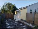 Exterior side view showcasing a yard with gravel and a wooden fence at 1834 28Th N Ave, St Petersburg, FL 33713