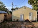 Backyard exterior featuring a small shed and an access door at 1834 28Th N Ave, St Petersburg, FL 33713