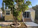 View of the home's rear exterior, with a patio area and lush foliage at 1834 28Th N Ave, St Petersburg, FL 33713