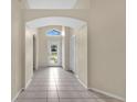 Bright entryway with tiled floors, high ceilings, and views to the front door and the front yard at 22802 Roderick Dr, Land O Lakes, FL 34639