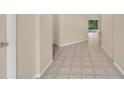 Hallway showcasing neutral walls, and tiled flooring leading to other rooms at 22802 Roderick Dr, Land O Lakes, FL 34639