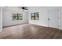 Bright living room showcases new laminate floors, fresh paint, and abundant natural light from large windows at 9033 3Rd N St, St Petersburg, FL 33702
