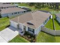 Stunning aerial view of the home, showcasing its great landscaping and proximity to the neighborhood lake at 10815 Laxer Cay Loop, San Antonio, FL 33576