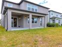 Open backyard with covered patio and well maintained lawn at 3137 Marine Grass Dr, Wimauma, FL 33598