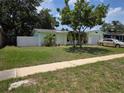 Inviting single-Gathering home with a charming front yard, mature tree, and attached garage at 1079 Woodbrook S Dr, Largo, FL 33770