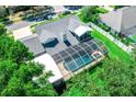 Aerial view of a backyard featuring a screened-in pool area, perfect for outdoor entertaining at 3009 Ridgevale Cir, Valrico, FL 33596