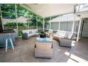 Spacious screened patio with comfortable seating and an outdoor entertainment area at 3009 Ridgevale Cir, Valrico, FL 33596