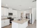 Modern kitchen features granite counters, stainless appliances, a kitchen island, and ample cabinet space at 3550 Moscato Dr, Brooksville, FL 34602