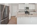 Modern kitchen with stainless steel appliances, granite countertops, and white cabinets at 3921 Radiant Mountain Dr, Plant City, FL 33565
