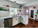 Bright kitchen featuring stainless steel appliances, granite countertops, and stylish shelving, offering both functionality and charm at 420 61St S Ave, St Petersburg, FL 33705