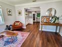 Inviting living room features hardwood floors, bright light, and seamless open floor plan to kitchen at 420 61St S Ave, St Petersburg, FL 33705