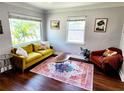 Cozy living room with large windows, hardwood floors, and bright décor, perfect for relaxing or entertaining at 420 61St S Ave, St Petersburg, FL 33705