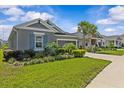 A well-kept single-story home with an attached two-car garage and lush green landscaping at 10516 Tranquil Meadow Loop, Riverview, FL 33569