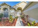 Inviting home entrance with beautiful landscaping leading to the front door at 4305 Balmoral Ct, Wesley Chapel, FL 33543