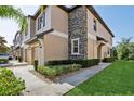 Attractive townhome showcasing a stone exterior accent, meticulous landscaping and sidewalk at 11632 Castine St, New Port Richey, FL 34654