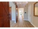 Grand foyer with wood-look tile flooring, sliding barn doors, and a view of the staircase at 4861 Antrim Dr, Sarasota, FL 34240