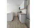 This simple kitchen has stainless steel appliances, granite countertops, and vinyl floors at 8612 N Alaska St, Tampa, FL 33604