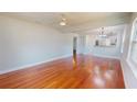 Bright living area featuring hardwood floors, a ceiling fan, and seamlessly connects to the dining area at 2456 S 17Th S Ave, St Petersburg, FL 33712