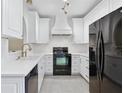 Bright kitchen featuring white cabinets and stainless steel appliances at 2731 Penzance St, Palm Harbor, FL 34684