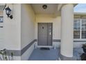Inviting front entryway features decorative columns and a charming, gray front door at 3118 34Th Avenue E Dr, Bradenton, FL 34208